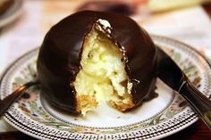 a chocolate covered dessert sitting on top of a white plate