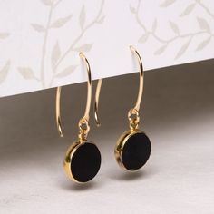 "Black onyx and gold stunning circle drop earrings for her - Unique, elegant, minimalist jewelry gift ideas for you, wife, mom, aunt, niece Stone: Genuine Black Onyx Bezel: Vermeil Gold Ear-wire: 14k Gold Filled Total length of earring: 35mm Circle Gemstone: 12mm diameter About \"Gold Filled Jewelry\": Also called rolled-gold. These jewelry items are not actually filled with gold. They are made of a base metal covered by sheets of gold in a mechanical bonding process. Effectively a thick coat of Black And Gold Earrings, Jingle Jangle, Aunt Niece, Jewelry Knowledge, Master Board, Jewelry Gift Ideas, Celestial Sun, Thick Coat, Gemstone Drop Earrings