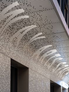 the ceiling is covered with white dots in an office building's entryway area