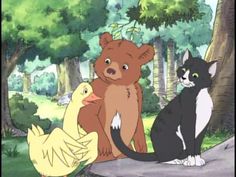 two cats and a bear sitting in the woods