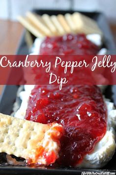 cranberry pepper jelly dip with crackers on the side and text overlay