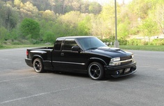 a black truck parked in a parking lot