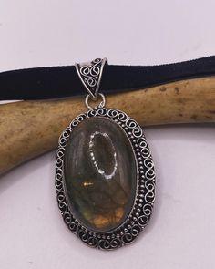 Add a touch of timeless elegance to your look with this stunning vintage Labradorite black velvet choker necklace from TomWayne Jewelers! 💎❤️ Featuring a beautiful pendant and intricate details, this choker is the perfect addition to any outfit. Pin now and get ready to shine! #VintageJewelry #PendantNecklace #Choker #Labradorite #TomWayneJewelers Unique Metal Pendant Choker, Adjustable Vintage Metal Choker, Spiritual Green Labradorite Necklace, Unique Labradorite Pendant Necklace, Black Labradorite Pendant Necklace, Black Velvet Choker Necklace, Velvet Choker Necklaces, Black Velvet Choker, Statement Choker Necklace