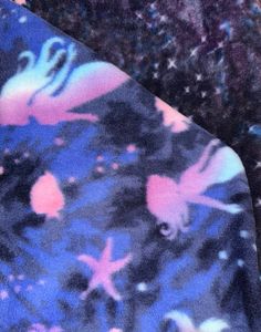 the tie is blue and has pink flowers on it, as well as other colors