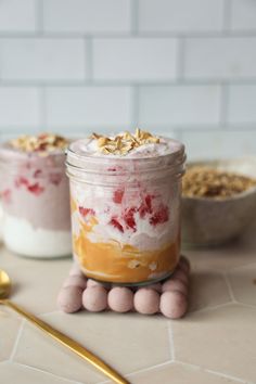 two jars filled with food sitting on top of a counter