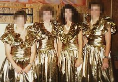 several women in gold dresses standing next to each other