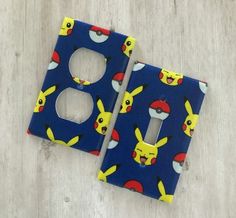 two blue switch plates with pikachu faces on them