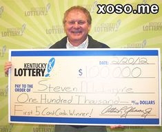 a man holding up a large cheque for $ 100, 000 from kentucky lottery