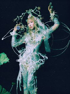 a woman dressed as a fairy holding a wand