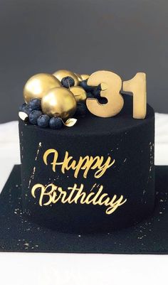 a black and gold birthday cake with the number thirteen on it