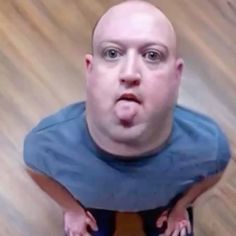 a man making a funny face while sitting on the floor