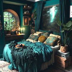 a bed with green sheets and pillows in a room next to a painting on the wall