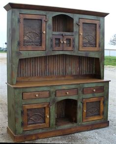 an old wooden hutch sitting in the middle of a field with grass and dirt