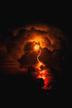 a large cloud with lightning coming out of it's center surrounded by dark clouds