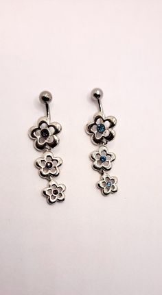 two pairs of earrings with flowers on them