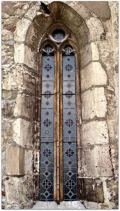 an old stone building with stained glass windows