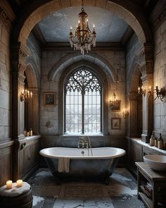 an old fashioned bathtub in a stone walled bathroom with chandelier and windows