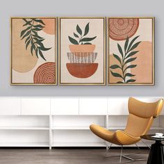 three paintings hanging on the wall in a living room