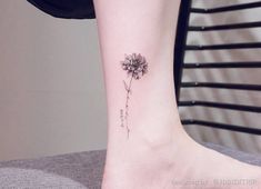 a small flower tattoo on the ankle