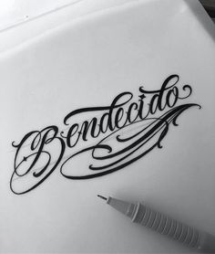 a pen sitting on top of a paper with the word benedicto written in cursive writing