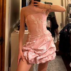 a woman in a pink dress taking a selfie