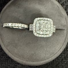 a diamond ring sitting on top of a cushion