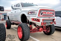 a large white ram truck parked in a parking lot