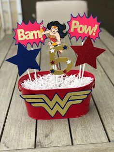 there is a cupcake in the shape of a wonder woman with stars on it