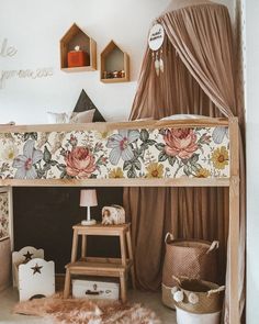 a child's bedroom with a floral canopy bed