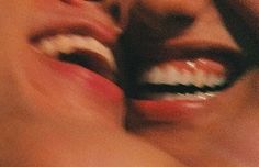 a close up of two people with their mouths open