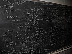 a blackboard with many calculations written on it