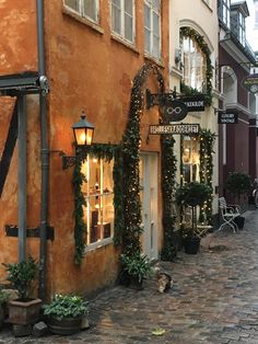 an old building with christmas lights on the windows and decorations hanging from it's side