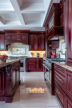 a large kitchen with red cabinets and marble counter tops, along with white tile flooring