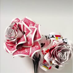 a rose made out of playing cards on top of a table