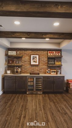 a kitchen with wooden flooring and brick built - in shelves on the wall above it