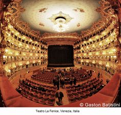 an auditorium with people standing in it