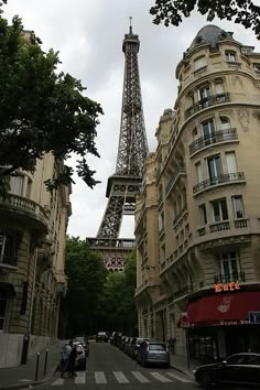 the eiffel tower towering over the city of paris, france as seen from an empty street