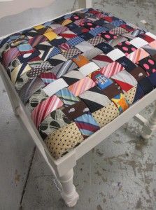 a patchwork foot stool made out of ties on it's seat cushion is shown