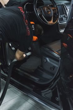 a man is cleaning the inside of a car