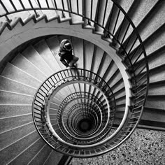 a man is climbing up the spiral staircase