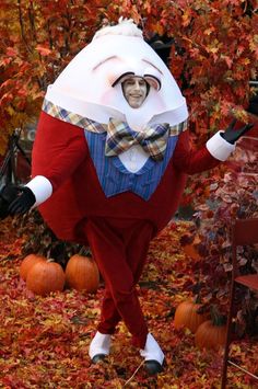 a man in a costume is walking through the leaves