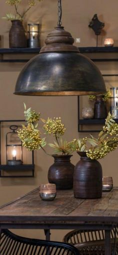 two vases with flowers are sitting on a table