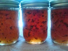 three jars filled with food sitting on top of a table