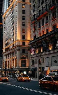 a city street filled with lots of traffic next to tall buildings in the middle of night