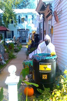 a man dressed up as a scarecrow in front of a house