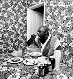 a man sitting at a table with food in front of him