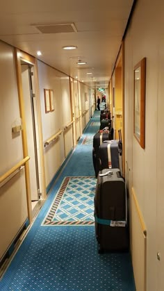 several suitcases are lined up in the hallway on either side of the door way