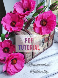 some pink flowers sitting on top of a white window sill next to a wooden box