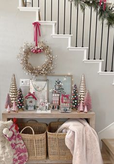 christmas decorations and wreaths on the banister in this entryway decorated for christmas