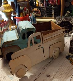 a toy truck sitting on top of a wooden table next to other toys and supplies